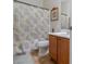 Bathroom featuring a tile floor, shower with butterfly-themed curtain, vanity with cabinet, and framed mirror at 6061 Moonlight Sonata Ave, Las Vegas, NV 89122
