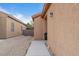 Tan single-story home featuring a small rock landscape on the side at 6061 Moonlight Sonata Ave, Las Vegas, NV 89122