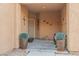 Inviting front porch with decorative potted plants and wall art at 6061 Moonlight Sonata Ave, Las Vegas, NV 89122