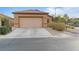 A lovely single-story home featuring a two-car garage and desert landscaping at 6061 Moonlight Sonata Ave, Las Vegas, NV 89122