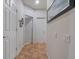 Well-lit hallway with tile flooring, neutral walls and white doors creating a clean, bright space at 6061 Moonlight Sonata Ave, Las Vegas, NV 89122