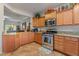 Modern kitchen with granite countertops, stainless steel appliances, and wooden cabinets at 6061 Moonlight Sonata Ave, Las Vegas, NV 89122