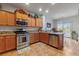 Well-lit kitchen with wooden cabinets and stainless steel appliances at 6061 Moonlight Sonata Ave, Las Vegas, NV 89122