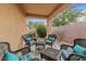 Covered outdoor patio with patio furniture surrounded by desert landscaping at 6061 Moonlight Sonata Ave, Las Vegas, NV 89122