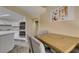 Well-lit dining area with seating, easy access to the kitchen, and neutral colors at 7217 Mission Hills Dr, Las Vegas, NV 89113