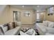 Bright living room with wood floors and white couches at 7217 Mission Hills Dr, Las Vegas, NV 89113