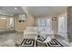 Bright living room featuring wood floors, a stone fireplace, and white couches at 7217 Mission Hills Dr, Las Vegas, NV 89113