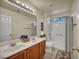 Bright bathroom featuring double sinks, a large mirror, and a shower-tub combo at 8421 Cheerful Brook Ave, Las Vegas, NV 89143