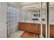 Bathroom featuring double sinks with a large mirror, and a bathtub with shower curtain at 8421 Cheerful Brook Ave, Las Vegas, NV 89143