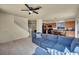 Open-concept floorplan with stairs leading up, tile floors, and kitchen with black appliances and wood cabinets at 8421 Cheerful Brook Ave, Las Vegas, NV 89143