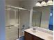 Bathroom featuring a glass-enclosed shower-tub and double sink vanity at , Las Vegas, NV 89178