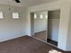 Bright bedroom featuring neutral carpet, mini-blinds, and a mirrored closet at , Las Vegas, NV 89178