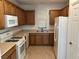 Functional kitchen featuring white appliances and wooden cabinets at , Las Vegas, NV 89178
