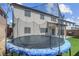 Backyard view showcasing the home's exterior, a trampoline, and privacy fencing at 10135 Haymarket Peak Ave, Las Vegas, NV 89166