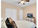 Bedroom features a comfy bed with throw pillows, closet doors, and warm, neutral tones at 10135 Haymarket Peak Ave, Las Vegas, NV 89166