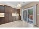 Bright kitchen featuring dark cabinets, backyard access and stainless appliances, perfect for Gathering meals and entertaining at 10135 Haymarket Peak Ave, Las Vegas, NV 89166