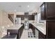 Well-equipped kitchen with stainless appliances, dark cabinetry, granite countertops, and a convenient center island at 10135 Haymarket Peak Ave, Las Vegas, NV 89166