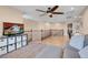 Second-floor loft area, complete with a ceiling fan, office area and comfortable seating with sofa and ottoman at 10135 Haymarket Peak Ave, Las Vegas, NV 89166