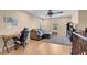 Second-floor loft with wood floors features an office space with a ceiling fan, perfect for working from home at 10135 Haymarket Peak Ave, Las Vegas, NV 89166