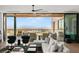 Bright living room with a ceiling fan, ample seating, and a sliding door to the terrace at 11660 Summit Club Dr # 204, Las Vegas, NV 89135