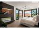 Serene primary bedroom featuring a fireplace, large sliding glass doors, and mountain views at 11660 Summit Club Dr # 204, Las Vegas, NV 89135