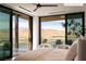 Bright primary bedroom with expansive windows showcasing beautiful mountain scenery and outdoor living at 11660 Summit Club Dr # 204, Las Vegas, NV 89135