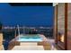 Relaxing outdoor pool and patio area with city skyline views in this luxurious modern home at 11660 Summit Club Dr # 204, Las Vegas, NV 89135