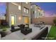 The backyard features an outdoor sofa and chairs, creating a relaxing space for lounging at 11676 Midnight Melody Ave, Las Vegas, NV 89138