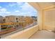A spacious balcony with views of the community and the mountains in the distance creates a perfect outdoor relaxation space at 11676 Midnight Melody Ave, Las Vegas, NV 89138
