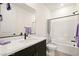 Modern bathroom with a sleek vanity, granite counters, and a shower-tub combo at 11676 Midnight Melody Ave, Las Vegas, NV 89138