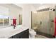 Bright bathroom featuring a modern vanity, glass enclosed shower with a built in seat, and contemporary fixtures at 11676 Midnight Melody Ave, Las Vegas, NV 89138