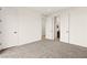Carpeted bedroom has multiple doors and hallways to other rooms in the house and a large closet at 11676 Midnight Melody Ave, Las Vegas, NV 89138