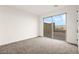 Cozy bedroom with carpet flooring, a sliding glass door, and backyard access that provides outdoor connection at 11676 Midnight Melody Ave, Las Vegas, NV 89138