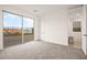 Bright bedroom features neutral carpet, a large sliding glass door to backyard and a hallway entrance at 11676 Midnight Melody Ave, Las Vegas, NV 89138