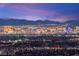 Las Vegas skyline views from a high-rise balcony, showcasing city lights and mountains at 11676 Midnight Melody Ave, Las Vegas, NV 89138