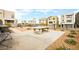 Community common area featuring picnic table and cornhole boards surrounded by walking path and landscaping at 11676 Midnight Melody Ave, Las Vegas, NV 89138