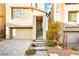 Charming home with a brick driveway, attached garage, landscaped front yard, and a welcoming front entrance at 11676 Midnight Melody Ave, Las Vegas, NV 89138