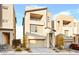 Attractive three-story home with a two-car garage and neutral-toned exterior at 11676 Midnight Melody Ave, Las Vegas, NV 89138