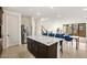 The open concept kitchen features an island with granite counters and stainless appliances that are perfect for entertaining at 11676 Midnight Melody Ave, Las Vegas, NV 89138