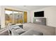 Contemporary living room with large windows and modern fireplace at 11676 Midnight Melody Ave, Las Vegas, NV 89138