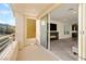 Bright living room showcases a fireplace, plush carpet, and sliding glass doors to a balcony with community views at 11676 Midnight Melody Ave, Las Vegas, NV 89138