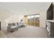 Bright and spacious living room with a modern fireplace, carpet, recessed lighting and access to a balcony at 11676 Midnight Melody Ave, Las Vegas, NV 89138