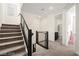 Carpeted staircase and landing featuring modern railings and lighting, with access to upstairs bedrooms at 11676 Midnight Melody Ave, Las Vegas, NV 89138