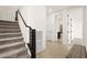 Stairway with carpeted steps and a dark handrail that leads to multiple rooms and hallways in the house at 11676 Midnight Melody Ave, Las Vegas, NV 89138
