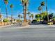 Community entrance with lush palm trees, greenery, and a welcoming sign at 1881 W Alexander Rd # 2117, North Las Vegas, NV 89032