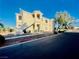 A two-story condo building with stucco exterior, desert landscaping, and a blue sky backdrop at 1881 W Alexander Rd # 2117, North Las Vegas, NV 89032