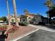 Attractive community building, complemented by palm trees and colorful flowerbeds, enhancing curb appeal at 1881 W Alexander Rd # 2117, North Las Vegas, NV 89032