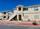 Well-maintained condo building with a private balcony and desert landscaping enhances curb appeal at 1881 W Alexander Rd # 2117, North Las Vegas, NV 89032
