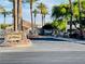 Gated community entrance with mature palm trees and green landscaping at 1881 W Alexander Rd # 2117, North Las Vegas, NV 89032