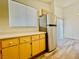 Cozy kitchen area features wood floors, window and stainless steel refrigerator at 1881 W Alexander Rd # 2117, North Las Vegas, NV 89032